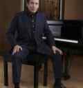 Jools Holland sitting at the piano photo by Mary Mc Cartney